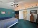 This well-lit bedroom features two beds, an entertainment center, and a vaulted ceiling at 3451 Sagebrush Ave, Pahrump, NV 89048