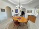 Bright dining area with wood table, chandelier lighting, and easy access to other living spaces at 3451 Sagebrush Ave, Pahrump, NV 89048
