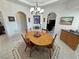 Traditional dining room featuring a round wood table, chandelier, and decorative archways at 3451 Sagebrush Ave, Pahrump, NV 89048