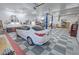 Large garage interior with checkerboard floors, car lift, and white car at 3451 Sagebrush Ave, Pahrump, NV 89048