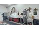 Garage featuring a sink, work bench, tool chest, water heater, and storage at 3451 Sagebrush Ave, Pahrump, NV 89048