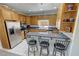 Modern kitchen with stainless steel appliances, breakfast bar seating, and ample storage at 3451 Sagebrush Ave, Pahrump, NV 89048