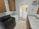 Efficient laundry room equipped with cabinets and a utility sink at 3451 Sagebrush Ave, Pahrump, NV 89048
