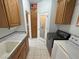 Functional laundry room with storage, sink and modern appliances at 3451 Sagebrush Ave, Pahrump, NV 89048