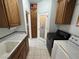 Practical laundry room with cabinets and a sink adjacent to the machines at 3451 Sagebrush Ave, Pahrump, NV 89048