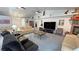 Open living room with stone fireplace, vaulted ceilings, and comfortable seating at 3451 Sagebrush Ave, Pahrump, NV 89048