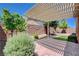 Backyard featuring a pergola, brick patio, artificial grass, and block wall at 3616 Greenbriar Bluff Ave, North Las Vegas, NV 89081