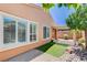 Backyard view of the home with windows, a covered patio, and desert landscaping at 3616 Greenbriar Bluff Ave, North Las Vegas, NV 89081