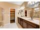 Double sink vanity in bathroom with walk-in shower and walk-in closet at 3616 Greenbriar Bluff Ave, North Las Vegas, NV 89081