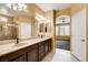 Dual vanity sink in bathroom with large mirror, shower, and natural light at 3616 Greenbriar Bluff Ave, North Las Vegas, NV 89081