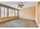 Spacious bedroom with neutral tones, ceiling fan, and natural light from large windows at 3616 Greenbriar Bluff Ave, North Las Vegas, NV 89081