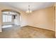 The spacious dining room with carpet flooring has a charming chandelier at 3616 Greenbriar Bluff Ave, North Las Vegas, NV 89081