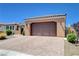 Single-story home showcasing a brick paver driveway, a two-car garage, and desert landscaping at 3616 Greenbriar Bluff Ave, North Las Vegas, NV 89081