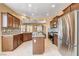 Spacious kitchen with a central island, stainless appliances, granite counters, and tile backsplash at 3616 Greenbriar Bluff Ave, North Las Vegas, NV 89081