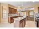 Open kitchen boasts an island, stainless steel appliances, granite counters, and tile backsplash at 3616 Greenbriar Bluff Ave, North Las Vegas, NV 89081