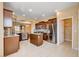 Open kitchen features stainless appliances, tile floors, center island and pantry at 3616 Greenbriar Bluff Ave, North Las Vegas, NV 89081