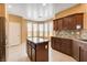 Bright kitchen with an island, stainless steel appliances, granite countertops, and tile flooring at 3616 Greenbriar Bluff Ave, North Las Vegas, NV 89081