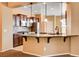 Charming kitchen featuring granite counters, tile backsplash, stainless appliances, and an eat-in bar at 3616 Greenbriar Bluff Ave, North Las Vegas, NV 89081