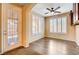 Sitting room features decorative glass door, shutters, wood floors and a ceiling fan at 3616 Greenbriar Bluff Ave, North Las Vegas, NV 89081