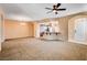 Spacious living area boasts a ceiling fan and access to the kitchen with bar seating at 3616 Greenbriar Bluff Ave, North Las Vegas, NV 89081