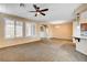 Spacious living area featuring neutral colors, a ceiling fan, and lots of natural light at 3616 Greenbriar Bluff Ave, North Las Vegas, NV 89081