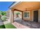 Covered patio featuring a ceiling fan, brick flooring, and view of the landscaped backyard at 3616 Greenbriar Bluff Ave, North Las Vegas, NV 89081