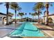 Resort-style pool area with palm trees, comfortable lounge seating, and a serene atmosphere at 3616 Greenbriar Bluff Ave, North Las Vegas, NV 89081