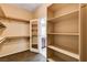 Bright walk-in closet with built-in shelves and closet rods with mirror at 3616 Greenbriar Bluff Ave, North Las Vegas, NV 89081