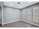 Bright bedroom with hardwood floors, natural light, and light gray walls at 3971 Foxboro Cir, Las Vegas, NV 89121