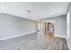 Spacious living room with gray walls and hardwood floors, open to the kitchen area at 3971 Foxboro Cir, Las Vegas, NV 89121