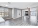 Open living room area with hardwood flooring, fireplace, and windows at 3971 Foxboro Cir, Las Vegas, NV 89121