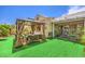 Backyard featuring a gazebo with outdoor seating and manicured landscape at 460 Strawflower Rd, Las Vegas, NV 89107