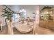 Dining space with a marble table, upholstered chairs, and decoratively adorned cabinets at 460 Strawflower Rd, Las Vegas, NV 89107