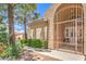 Charming home entrance with an arched gate, lush greenery, and a well-maintained walkway at 460 Strawflower Rd, Las Vegas, NV 89107