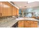 Inviting kitchen features granite counters, light wood cabinets and opens to the living area for seamless entertaining at 460 Strawflower Rd, Las Vegas, NV 89107