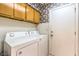 Laundry room showcasing a washer, dryer, and storage cabinets at 460 Strawflower Rd, Las Vegas, NV 89107