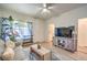 This spacious living room is brightly lit and features a mounted television and hardwood floors at 460 Strawflower Rd, Las Vegas, NV 89107