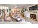 Bright living room with a fireplace, comfortable seating, and an open layout connecting to the kitchen at 460 Strawflower Rd, Las Vegas, NV 89107
