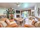 Comfortable living room with a fireplace, plush seating, and natural light streaming through the windows at 460 Strawflower Rd, Las Vegas, NV 89107
