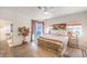 Bright main bedroom features hardwood floors, a ceiling fan and an ensuite bathroom at 460 Strawflower Rd, Las Vegas, NV 89107