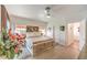 This bright main bedroom is decorated with plants and has a ceiling fan at 460 Strawflower Rd, Las Vegas, NV 89107