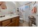 Traditional bathroom with wood vanity, shower with decorative curtain, and ample storage space at 5375 E La Campana Dr, Pahrump, NV 89061