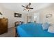 Comfortable bedroom featuring a ceiling fan, TV, and a view into the attached bathroom at 5375 E La Campana Dr, Pahrump, NV 89061