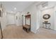 Inviting entryway featuring a wooden bench with coat hooks and neutral-toned tile flooring at 5375 E La Campana Dr, Pahrump, NV 89061