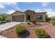 Charming single-story home with a two car garage, desert landscaping and stone accents at 5375 E La Campana Dr, Pahrump, NV 89061