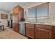 Kitchen with stainless steel dishwasher, wooden cabinets and countertops with decorative tile backsplash at 5375 E La Campana Dr, Pahrump, NV 89061