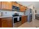 Kitchen features stainless steel appliances, tile backsplash, and ample wooden cabinets for storage at 5375 E La Campana Dr, Pahrump, NV 89061