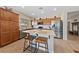 Modern kitchen with stainless steel appliances, wooden cabinetry and center island with bar stool seating at 5375 E La Campana Dr, Pahrump, NV 89061