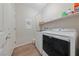 Efficient laundry room featuring a washer, dryer, and built-in storage shelves at 5375 E La Campana Dr, Pahrump, NV 89061
