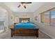 Serene main bedroom featuring a large bed, ceiling fan and a view of the backyard at 5375 E La Campana Dr, Pahrump, NV 89061
